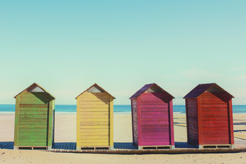 Fototapeta na wymiar Cabinas de madera para cambiarse de ropa en la playa de Cullera, Valencia, España