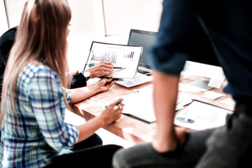 young employee discussing business documents with colleagues