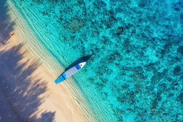 Boat near beach from top view. Turquoise water background from top view. Summer seascape from air. Gili Meno island, Indonesia. Travel Asia - image