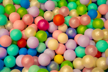 Fototapeta na wymiar Colorful child balls. Multi-colored plastic balls. Achildren's playroom. Background texture of multi-colored plastic balls on playground.