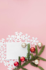 New year concept. Goals list in notepad, gift box and christmas decoration on pink pastel color with copy space