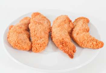 Delicious crispy fried breaded chicken breast strips . - Image
