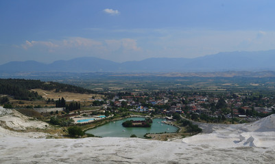 The famous Pamukkale (Cotton Castle) travertines and the lake captured in daytime.