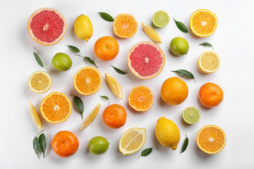 Fototapeta na wymiar Flat lay composition with tangerines and different citrus fruits on white background