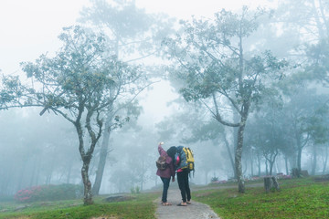Happy couple is enjoying the mist on the mountain