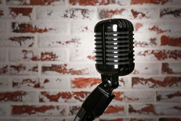 Fototapeta premium Retro microphone on brick background