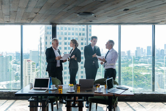 Business teamwork meeting and present start up new project.  People partners discussing graph of financial for investment in modern office.  City background.   Business and Teamwork Concept