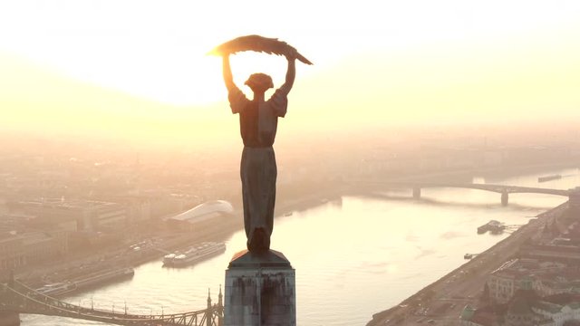 Budapest, Hungary, aerial view of Liberty Statue and Budapest cityscape at sunrise.