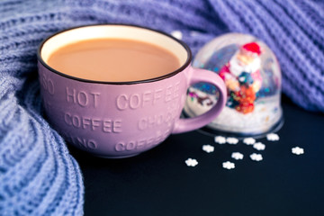 A Cup of coffee with milk in a cozy atmosphere, a winter drink with some decorations