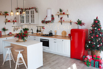 Modern Kitchen Interior with Island, Sink, Cabinets in New Luxury Home Decorated in Christmas Style.