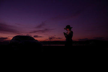 Women using smartphone at sunset