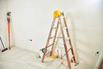 Tools and room in renovation progress, house remodeling, construction works.