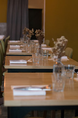 beautiful table setting with vases and dried flowers, napkins and cutlery