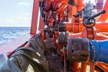 Transfer piping manifold on a boat at oil field