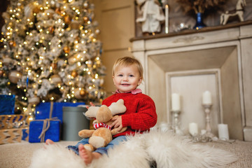 Funny girl near the Christmas tree.