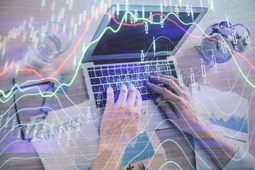 Multi exposure of forex graph with man working on computer on background. Concept of market analysis.