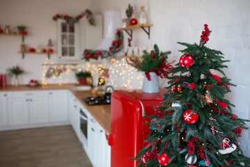 Modern Kitchen Interior with Island, Sink, Cabinets in New Luxury Home Decorated in Christmas Style.