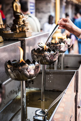 Chiang Mai, Thailand: Colorful and golden temple decoration in detail. Buddhist temple wat ornaments and buddha motives. Colorful flags and statues. Fire oblations.