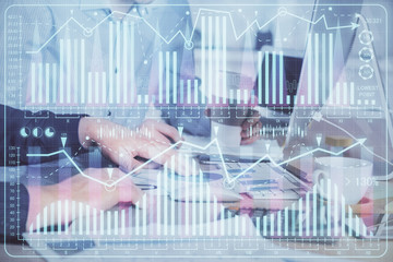 Multi exposure of chart with man typing on computer in office on background. Concept of hard work.