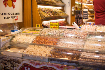  delicious street food and deserts. Traditional oriental sweet pastry cookies, Turkish desert with sugar, honey and pistachio, in display at a street food market