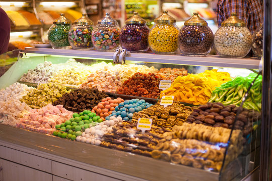 delicious street food and deserts. Traditional oriental sweet Turkish desert in display at a street food market. Colorful image of various sweets, candied fruit jelly at market stall
