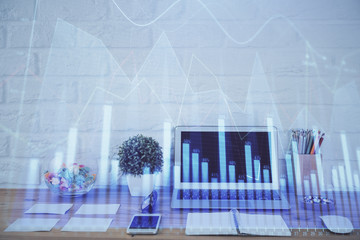 Forex market graph hologram and personal computer on background. Multi exposure. Concept of investment.