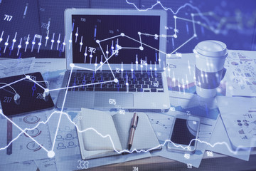 Financial chart drawing and table with computer on background. Multi exposure. Concept of international markets.