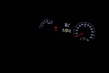 car dashboard illuminated at night