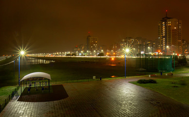 Evening city by the river embankment.