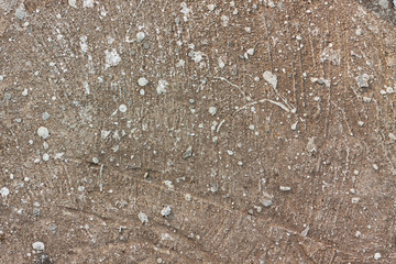 a flat stone surface with splashes of gray paint on it