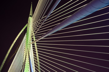Night view of modern bridge architecture at Putrajaya, Malaysia in different colors.