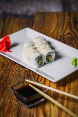 Fototapeta na wymiar Sushi rolls on wood