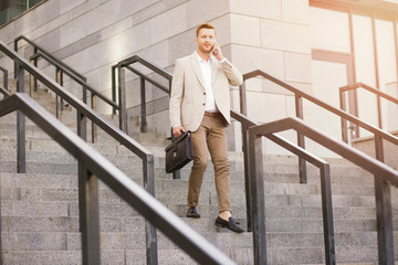 Elegantly dressed businessman with a cell phone stock photo