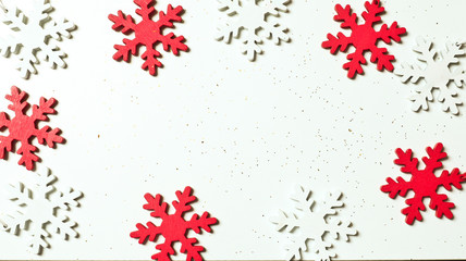 Christmas composition. Red and white snowflakes isolated on white background. Flat lay, top view, copy space