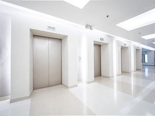 Modern steel elevator cabins in a business lobby or Hotel, Store, interior, office,perspective wide angle. Three elevators in hotel lobby.