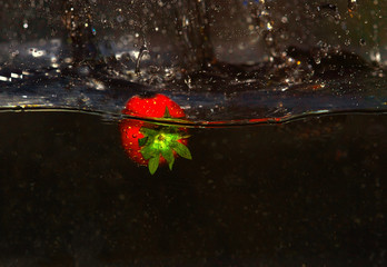 .Fresh strawberry in water with splashes