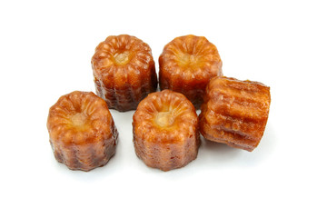 several cannelés on a white background