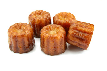 several cannelés on a white background