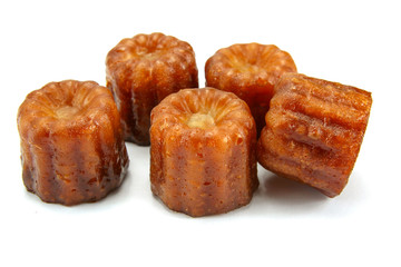 several cannelés on a white background