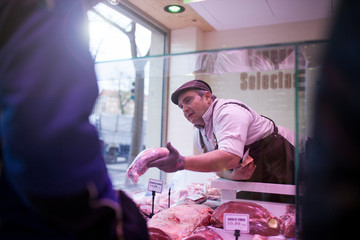 butcher serving at his butcher shop