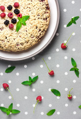 Homemade berry shortcrust pie with crumble on plate