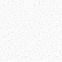 Seamless background made of light gray figures of irregular shape of different sizes placed chaotic on white background