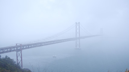 Most famous bridge in Lisbon on a foggy day - 25th of April bridge - travel photography