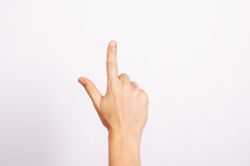 The man's hand isolated on white background. Gesture pointing, thumbs up, selection, pressing, indicating.