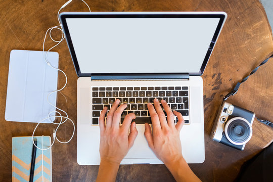 Young Beautiful Businesswoman Hands Typing On A Laptop On Her Desk . View From Above