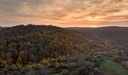 Aerial landscape panorama view of autumn mountain forest during sunset.
