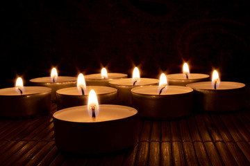Nine candles in the dark, focus on foreground