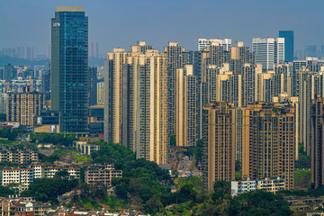 Fototapeta na wymiar Chongqing, China - March 20, 2018: City blocks on the hills. Top view of the Chinese city of Chongqing. Sunny day in metropolis.