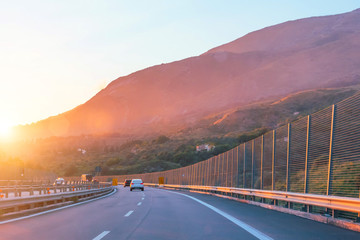 High-speed highway and turn on a background of mountains and sunset.