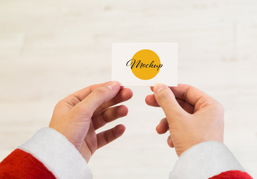 Hands of Santa Claus Holding a Business Card Mockup